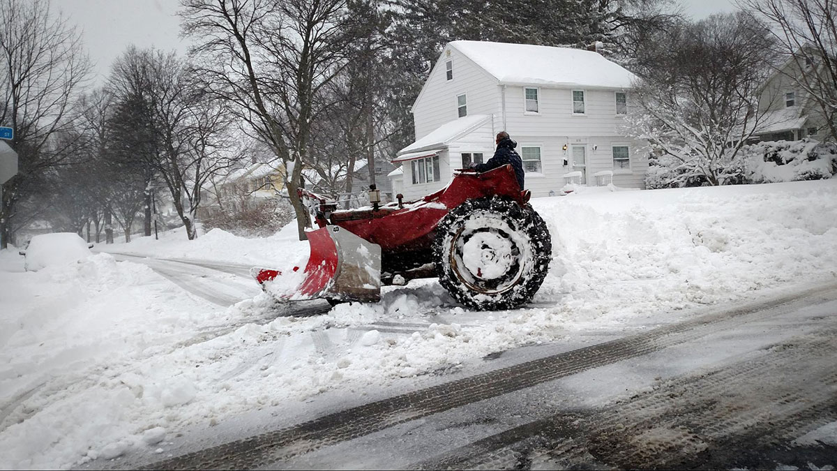 Winter sidewalk snowplow. Rochester NY.