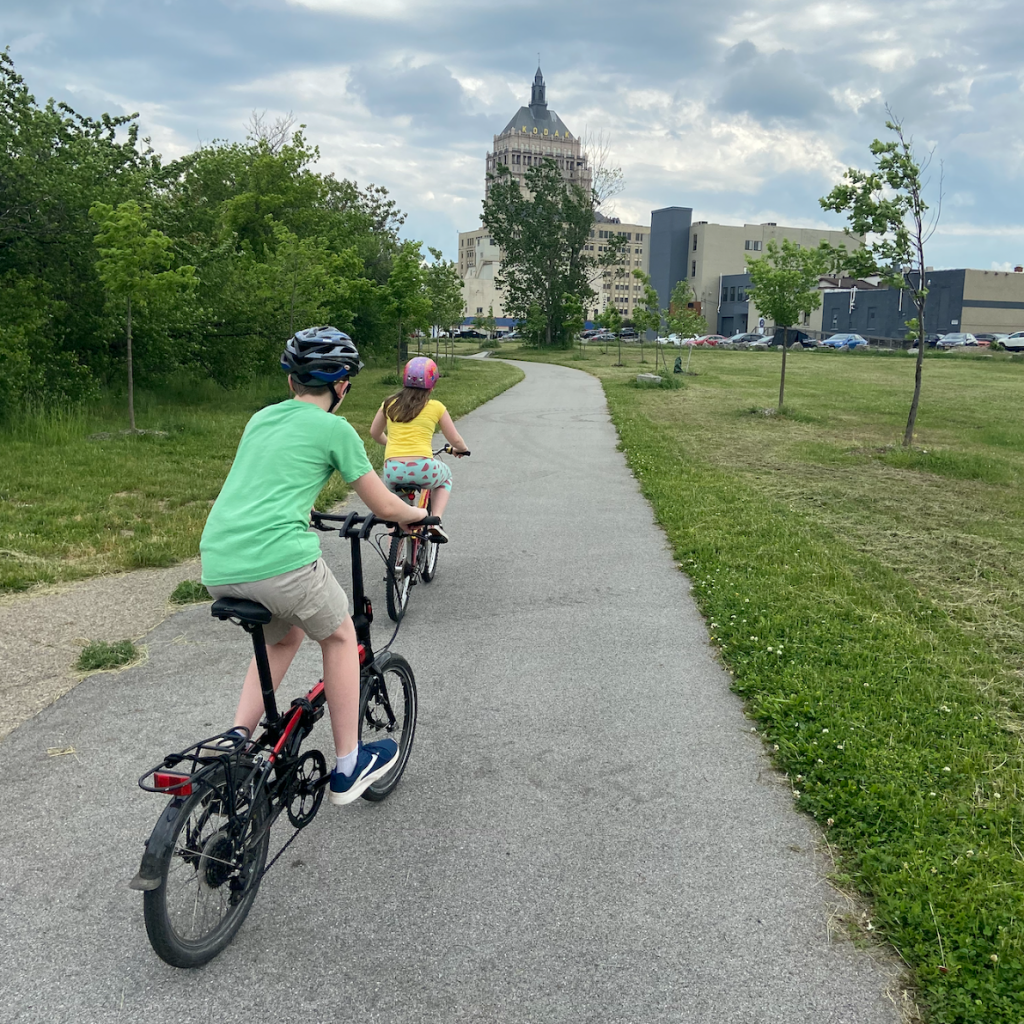 Kids ride on a bike path in Rochester