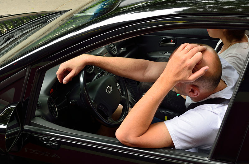 Stock image of a frustrated driver and passenger, perhaps in a traffic jam