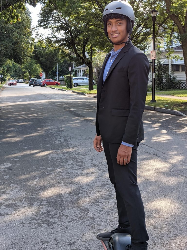 Car lite: Andre poses on his Onewheel in a suit, presumably on his way to work